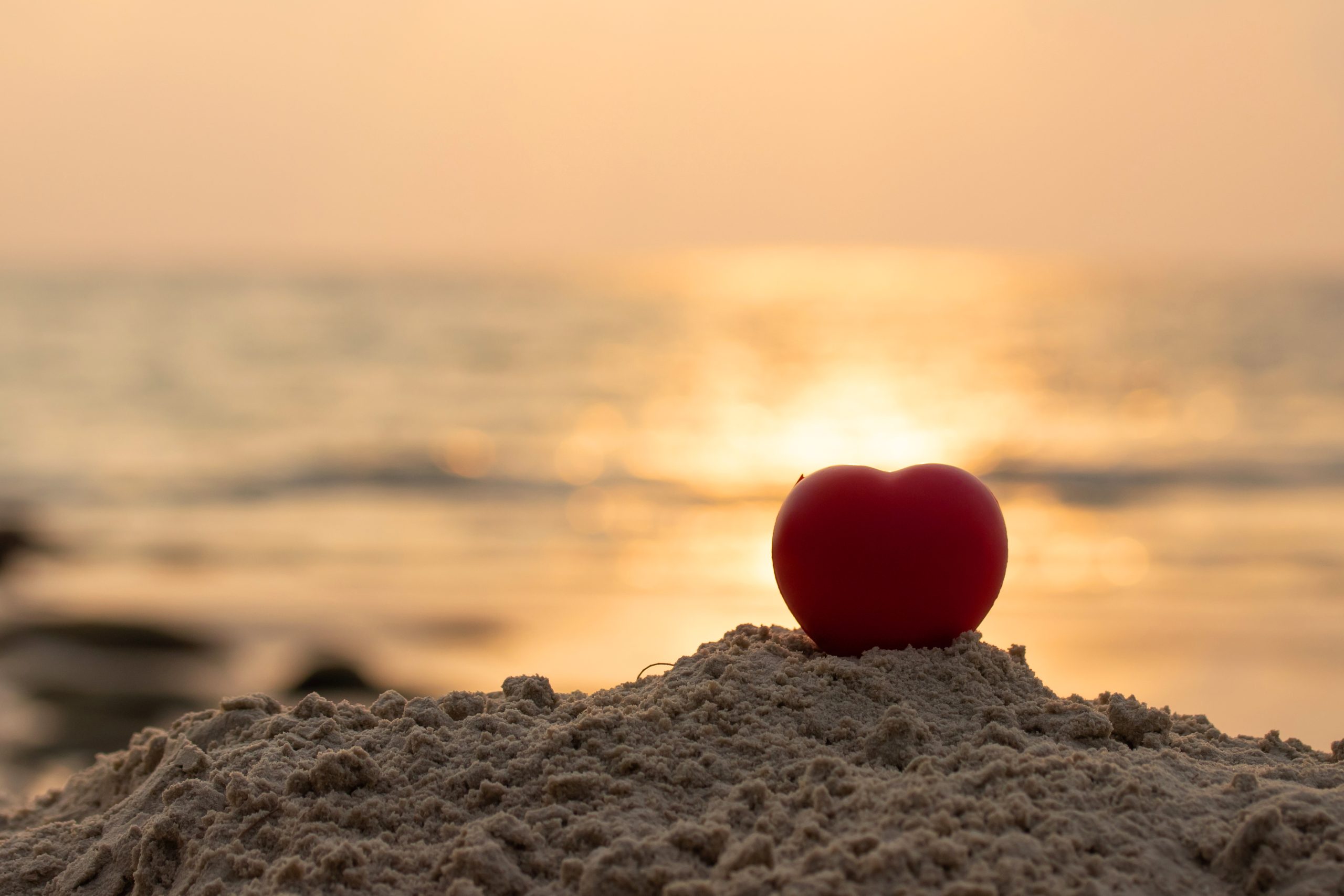 Valentine day and Marry Concept. Romantic love symbol red heart on the paradise tropical beach sunset or sunrise with copy space.